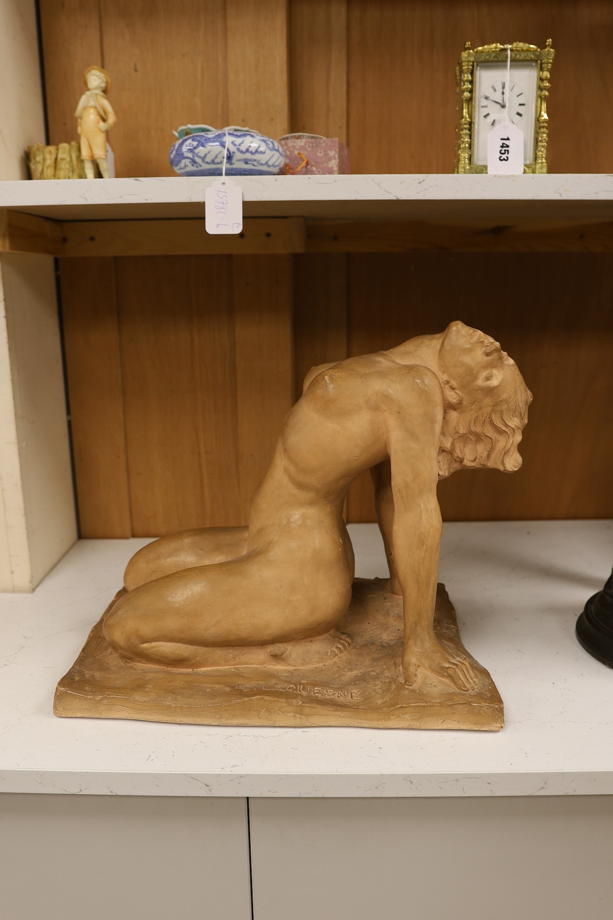 A French Art Deco terracotta semi reclining nude, stamped M. Lequesne, 36cm high. Condition - fair to good, slight scratches